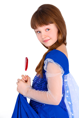 Beautiful child girl  holding a lollipop in the shape of a red heart valentines dayの写真素材