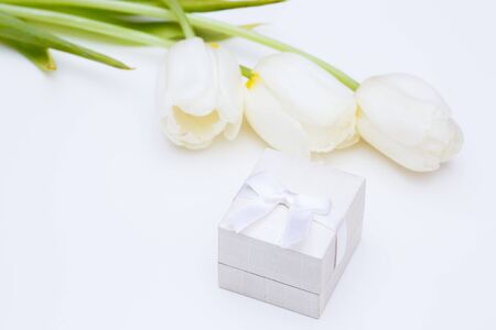 tulip and gold engagement ring on a white backgroundの写真素材