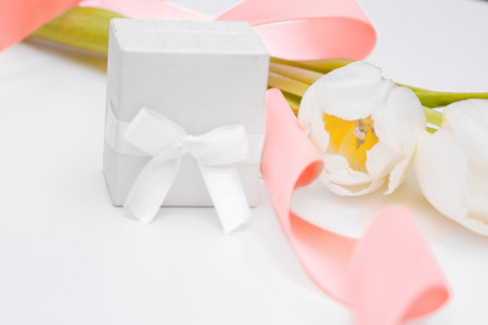 tulip and gold engagement ring on a white backgroundの写真素材