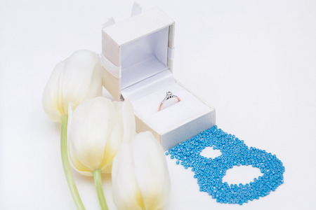 tulip and gold engagement ring on a white backgroundの写真素材