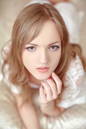 Beautiful bride in her bedroom. Soft light. morning brideの写真素材
