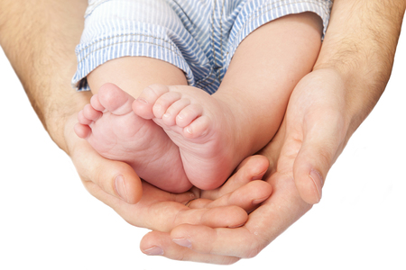 A father hold the feet of his new born son. baby legsの写真素材
