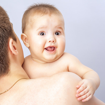 young father holding babyの写真素材