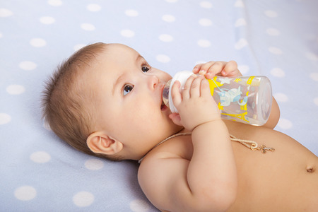 baby  drinking milk from bottleの写真素材
