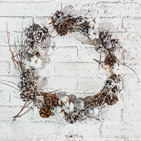 the Christmas wreath against a white brick wallの写真素材