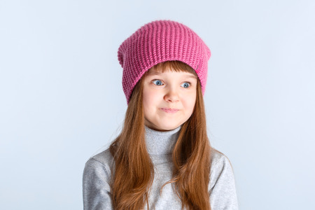 adorable smiling child girl wearing pink knitted hatの写真素材
