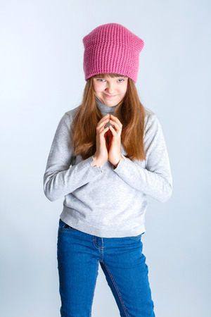 adorable smiling child girl wearing pink knitted hatの写真素材