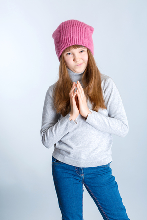 adorable smiling child girl wearing pink knitted hatの写真素材