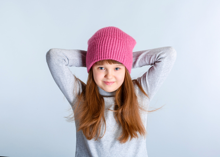 adorable smiling child girl wearing pink knitted hatの写真素材