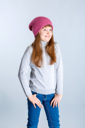 adorable smiling child girl wearing pink knitted hatの写真素材