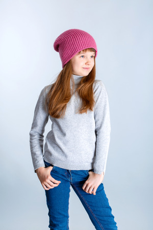 adorable smiling child girl wearing pink knitted hatの写真素材