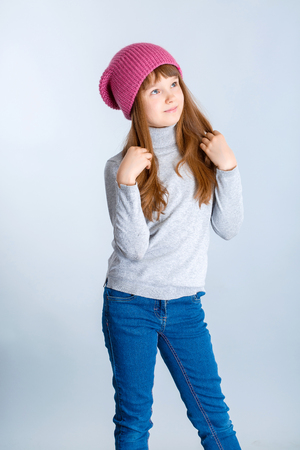adorable smiling child girl wearing pink knitted hatの写真素材