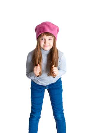 adorable smiling child girl wearing pink knitted hatの写真素材