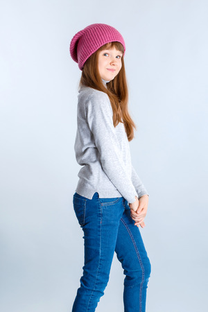 adorable smiling child girl wearing pink knitted hatの写真素材