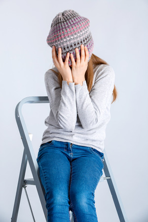 adorable smiling child girl wearing grey knitted hatの写真素材