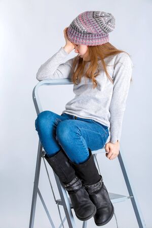 adorable smiling child girl wearing grey knitted hatの写真素材