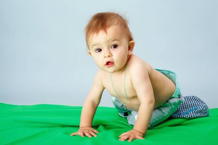 the beautiful little baby , lie on stomachの写真素材