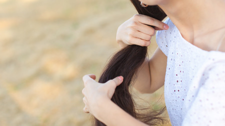 Young  woman in white dress in wheat field. girl in wheat fieldの写真素材