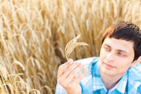 Happy man in hat on wheat field.の写真素材