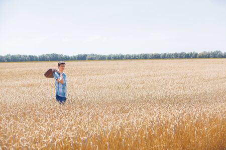 Happy man in hat on wheat field.の写真素材