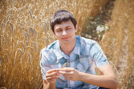 Happy man in hat on wheat field.の写真素材