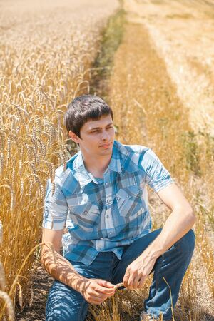 Happy man in hat on wheat field.の写真素材