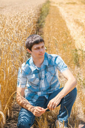 Happy man in hat on wheat field.の写真素材