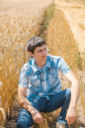 Happy man in hat on wheat field.の写真素材