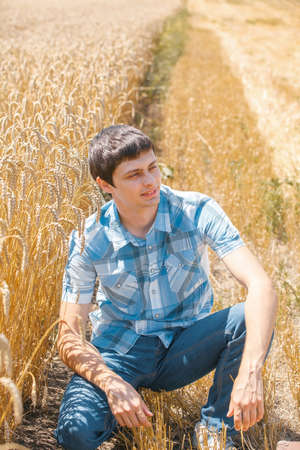 Happy man in hat on wheat field.の写真素材