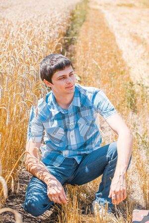 Happy man in hat on wheat field.の写真素材