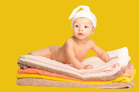 the baby on the colorful towels stackの写真素材