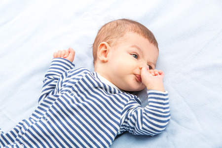 the beautiful little baby, lie on backの写真素材