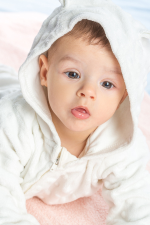 the beautiful little baby, lie  on stomach  on towelの写真素材