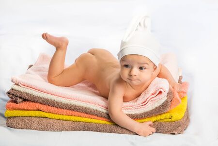 the beautiful baby on colorful towels stackの写真素材