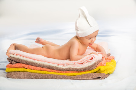 the beautiful baby on colorful towels stackの写真素材