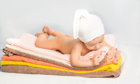 the beautiful baby on colorful towels stackの写真素材
