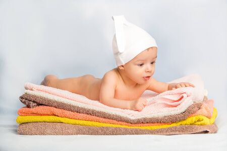 the beautiful baby on colorful towels stackの写真素材