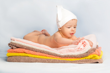 the beautiful baby on colorful towels stackの写真素材