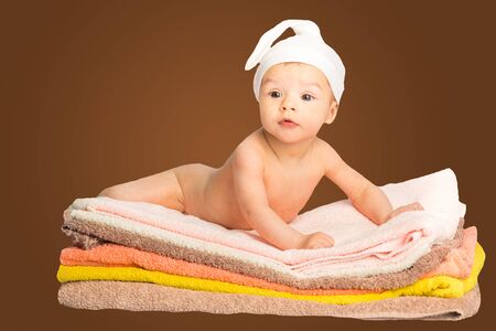 the baby on the colorful towels stackの写真素材