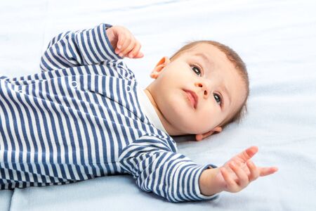 the beautiful little baby, lie on backの写真素材