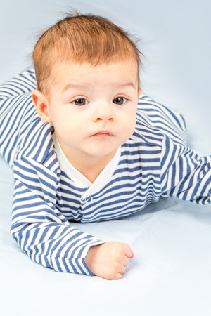 the beautiful little baby, lie  on stomachの写真素材