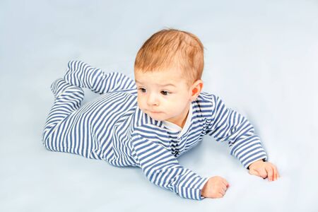 the beautiful little baby, lie  on stomachの写真素材