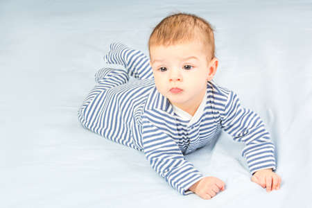 the beautiful little baby, lie  on stomachの写真素材