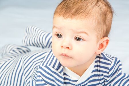 the beautiful little baby, lie  on stomachの写真素材