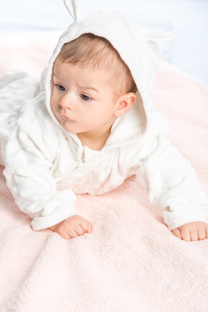 the beautiful little baby, lie  on stomach  on towelの写真素材
