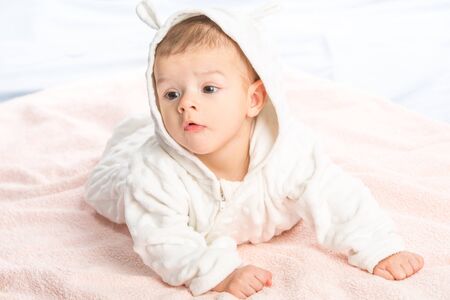 the beautiful little baby, lie  on stomach  on towelの写真素材