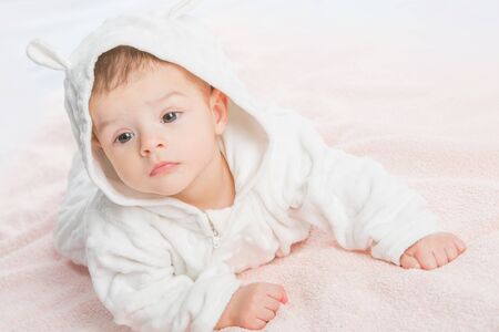 the beautiful little baby, lie  on stomach  on towelの写真素材