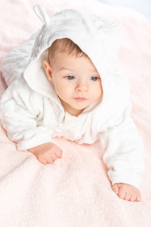 the beautiful little baby, lie  on stomach  on towelの写真素材