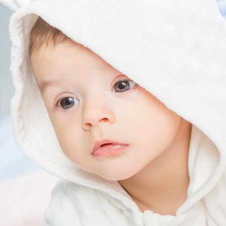 the beautiful little baby, lie  on stomach  on towelの写真素材