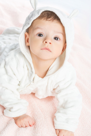 the beautiful little baby, lie  on stomach  on towelの写真素材